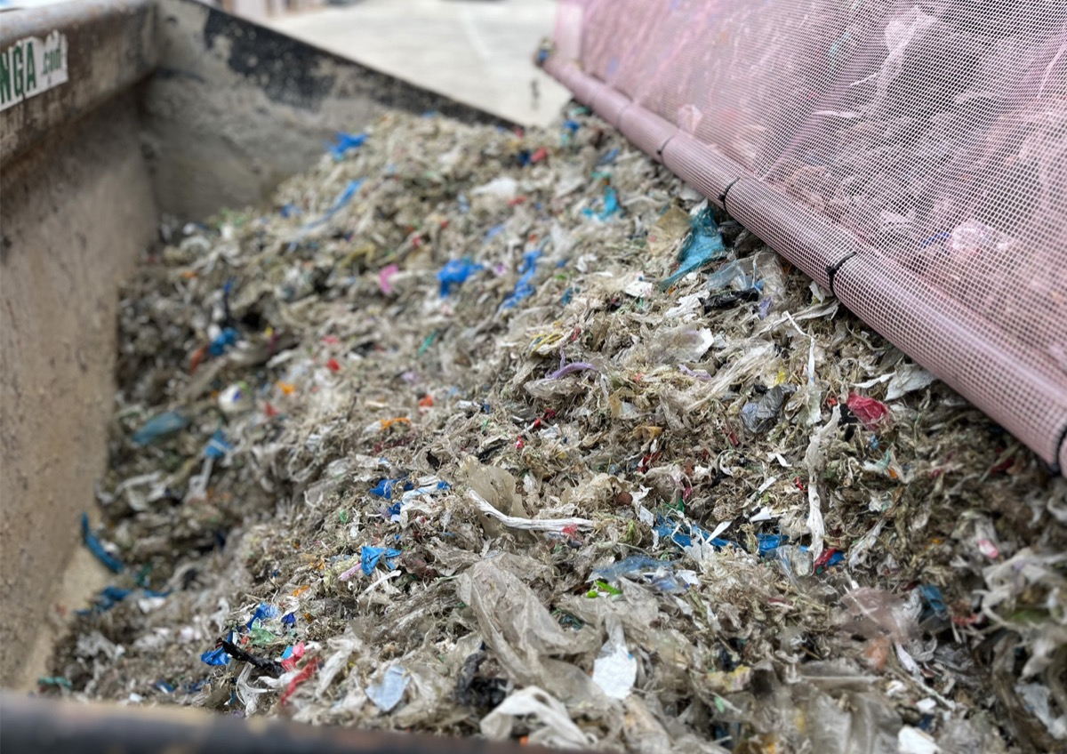 Dried de-packaged plastic waste discharged from FlowDrya drying bed into collection skip